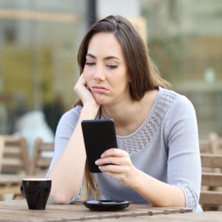 Bored girl looking at phone